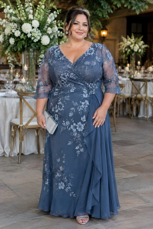 Blue Floral Evening Dress A woman wears a blue floral maxi dress with sheer sleeves, a draped skirt, silver clutch, and open-toe sandals.