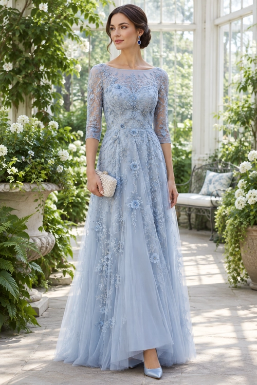 Elegant Blue Floral Gown Woman wearing a floor-length light blue floral lace gown with three-quarter sleeves, matching pointed shoes, drop earrings, and a small woven clutch.