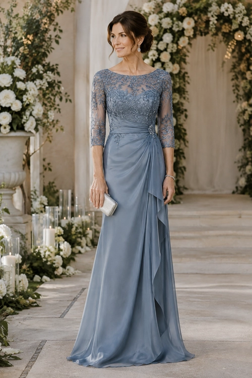 Blue Gray Lace Evening Gown Woman wearing a floor-length blue-gray gown with a lace bodice, sheer three-quarter sleeves, draped skirt, and ivory clutch.