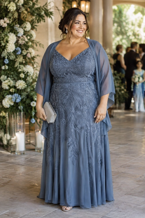 Blue Lace Evening Dress A woman wears a blue-gray floor-length lace dress with a sheer draped shawl and holds a silver clutch.