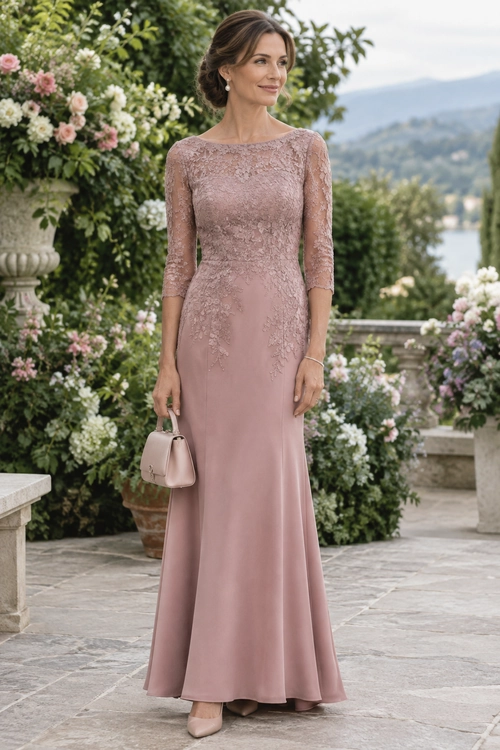 Woman wearing a dusty rose full-length lace gown with three-quarter sleeves, nude heels, and a small matching handbag in a flower-filled garden.