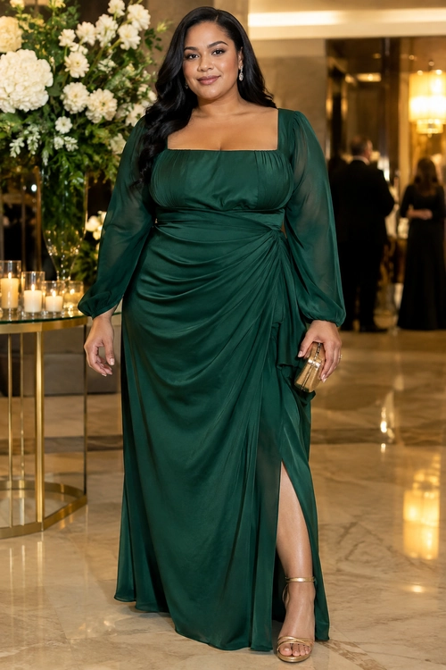 Emerald Green Draped Evening Dress A woman wears a dark emerald green ruched evening dress with sheer long sleeves, a square neckline, a thigh-high slit, gold sandals, and a gold clutch.