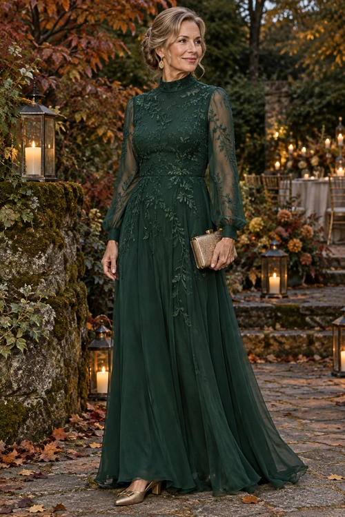 Emerald Green Lace Evening Dress A woman wears a floor-length forest green lace dress with sheer floral sleeves, a gold clutch, and metallic pointed-toe heels.