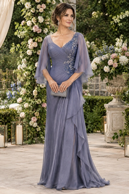 A woman wears a floor-length lavender chiffon gown with sheer flutter sleeves, floral embellishment, layered ruffles, and a silver clutch.