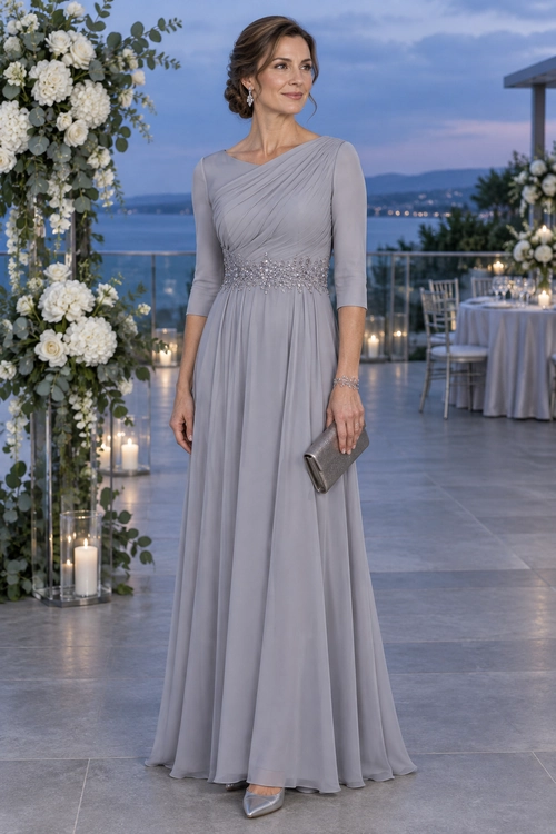 Woman wearing a lavender gray floor-length gown with a draped bodice, embellished waist, metallic clutch, bracelet, and pointed shoes.