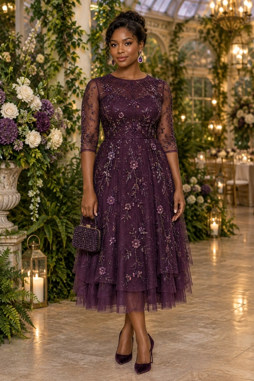 Woman wearing a plum floral embroidered midi dress with sheer sleeves, a beaded handbag, drop earrings, and matching pointed-toe heels.