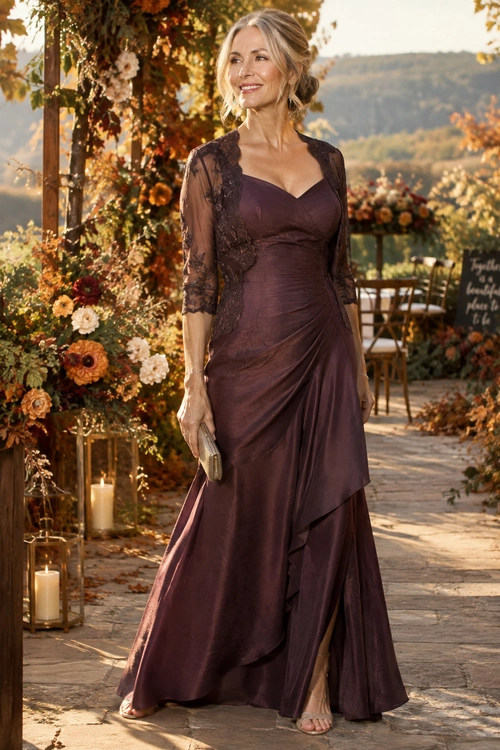 Plum Lace-Sleeve Evening Gown A woman wearing a long plum evening gown with sheer lace sleeves, a V-neckline, draped ruching, and an asymmetrical layered skirt.