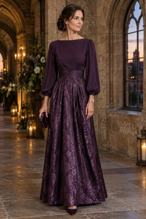 Woman wearing a deep plum satin long-sleeved top with a wide waistband and floor-length floral jacquard skirt.